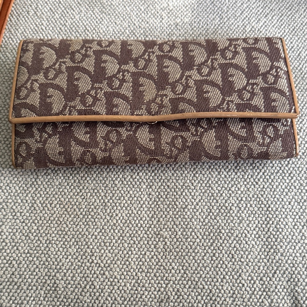 Dior Tan and Brown Monogram Wallet with snap clip close pouch.